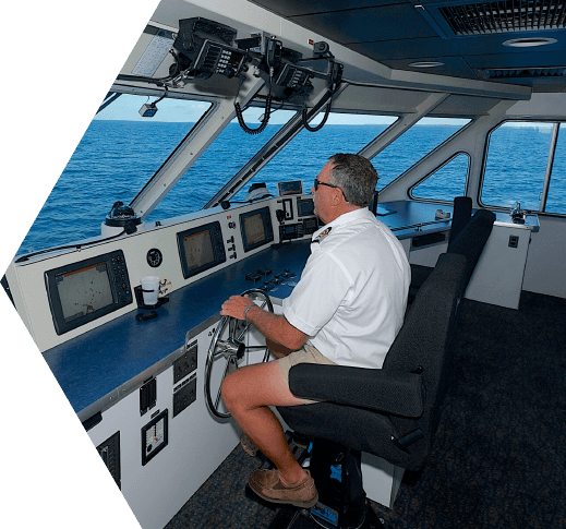 The captain of the Yankee Freedom on the bridge steering the catamaran towards the Dry Tortugas