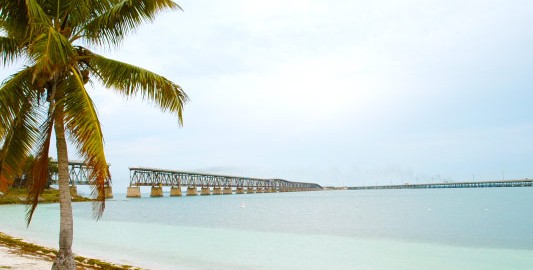 A distant view of the Bahia Honda Rail Bridge from the sand of Bahia Honda Beach in Key West