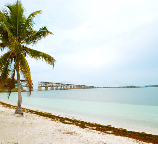 A distant view of the Bahia Honda Rail Bridge from the sand of Bahia Honda Beach in Key West