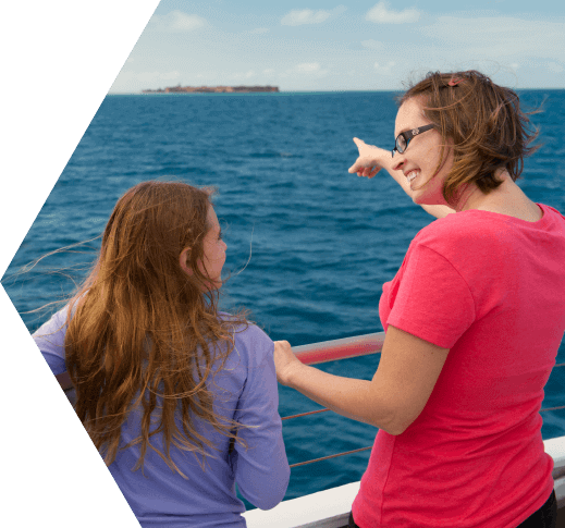 A mother pointing to Dry Tortugas National Park with her daughter by her side