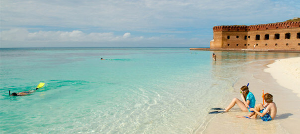 Dry Tortugas - Kids Sitting on beach with snorkel masks on