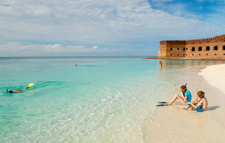 Dry Tortugas - Kids Sitting on beach with snorkel masks on